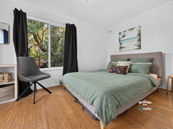 Bright bedroom featuring large window with natural light, contemporary furnishings, and a relaxed, inviting atmosphere.