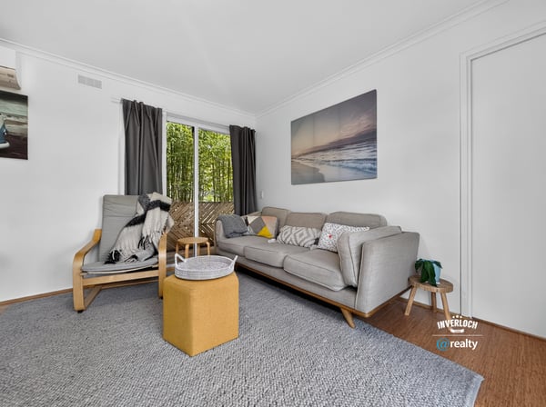 Bright and inviting living space featuring large windows, modern furnishings, and a seamless connection to outdoor views.