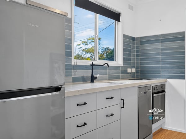 Modern kitchen featuring sleek appliances, ample storage, and natural light, perfect for culinary enthusiasts.