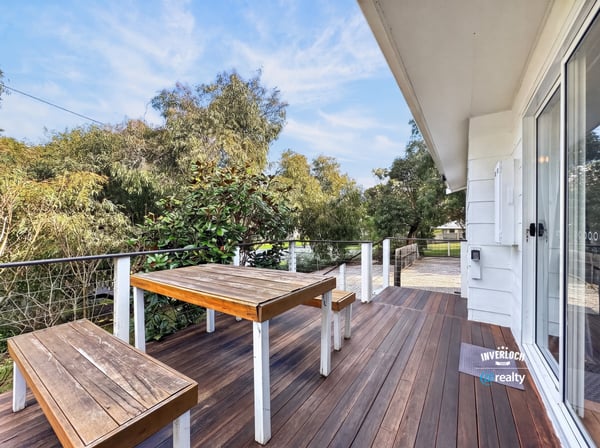 Expansive outdoor deck offers scenic views, perfect for entertaining or relaxing amidst nature.