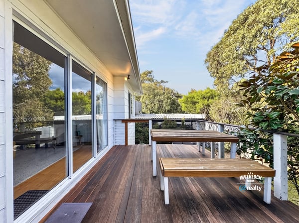 Enjoy outdoor living on this spacious deck, surrounded by lush greenery and natural beauty.
