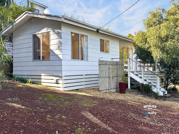 This inviting home features a spacious layout with large windows and a private outdoor area.