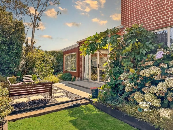 Discover this inviting outdoor space, featuring lush landscaping and a cozy seating area for relaxation.