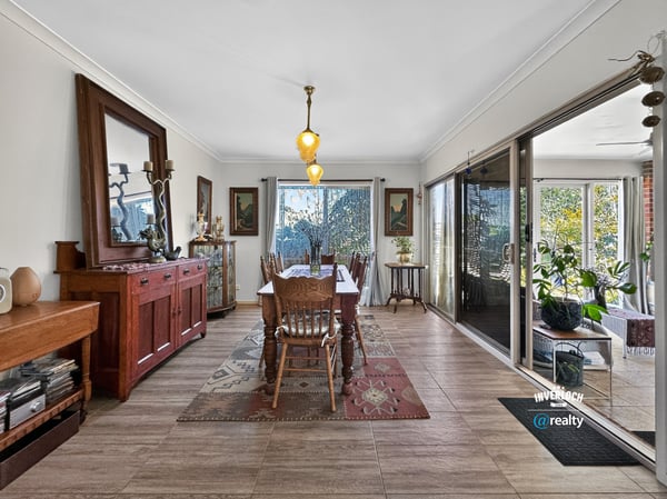 Spacious dining area featuring natural light, attractive décor, and easy access to a vibrant outdoor space.