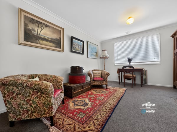 Bright and inviting living area featuring vintage decor, warm textiles, and ample natural light.
