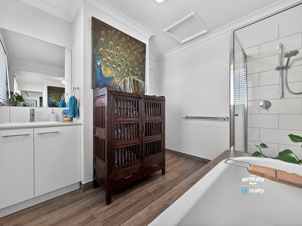 Contemporary bathroom featuring modern fixtures, natural light, and a unique wooden cabinet for added storage.