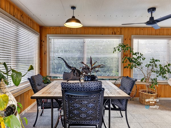 Bright and airy sunroom featuring ample natural light, perfect for relaxation or casual dining.