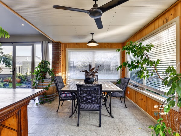 Bright and airy sunroom features large windows, perfect for enjoying peaceful views and entertaining guests.