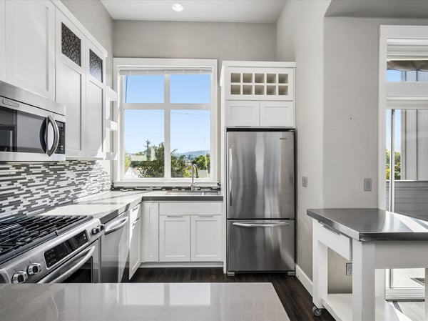 Quartz counters,KitchenAid, stainless steel appliance, gas range, built-in microwave.
