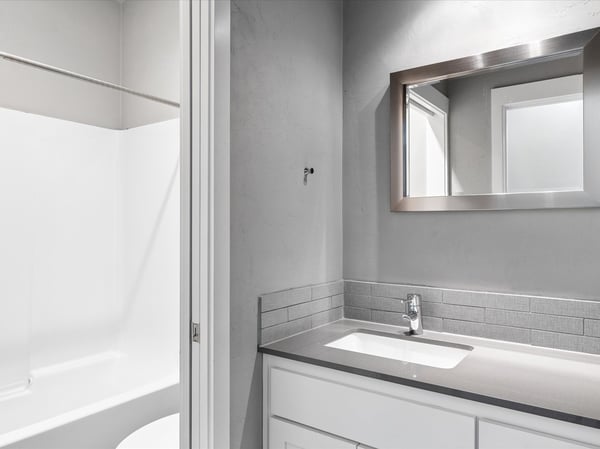 Main level bathroom adjacent to bedroom two.