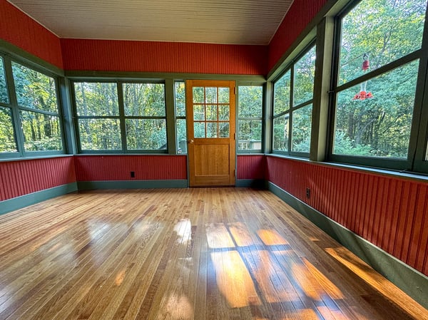 Kitchen opens to 3-Season Sunroom. NEW Insulated Hardwood Floor. Hand-built Door.