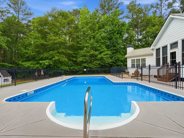 Discover a refreshing in-ground pool surrounded by spacious decking, perfect for outdoor relaxation and entertaining.