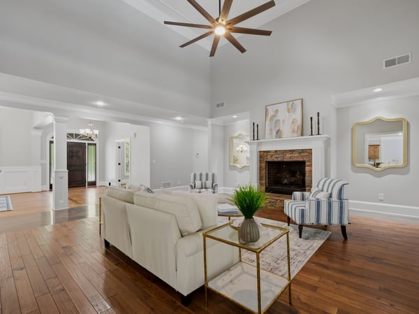 Spacious living area with soaring ceilings and natural light throughout.