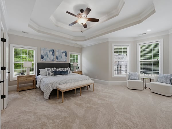 Spacious primary bedroom features an incredible trey ceiling, abundant natural light, and sitting area.
