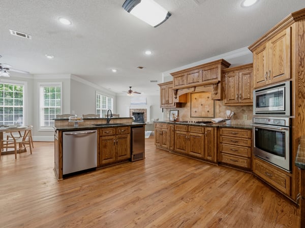Open concept kitchen with sub-zero fridge.