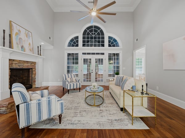 Spacious living area with soaring ceilings and natural light throughout.