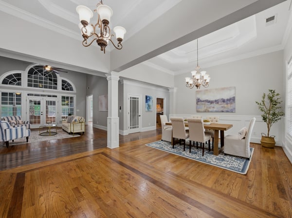Spacious open-concept living area featuring abundant natural light and refined detailing, perfect for gatherings and entertaining.