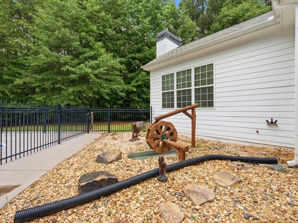 This well-maintained property features a unique outdoor space with a decorative water feature and landscaped rocks.