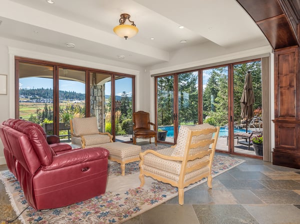Spacious living area featuring large windows that frame picturesque views, perfect for relaxation and entertaining. Formerly the site of an 8' Spencer Marston Venetian Pool Table, recently re-felted and ready to reassemble if an owner should wish.