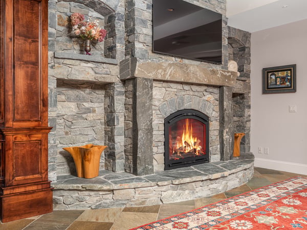 Cozy living space featuring a stunning stone fireplace, perfect for gatherings and relaxation.
