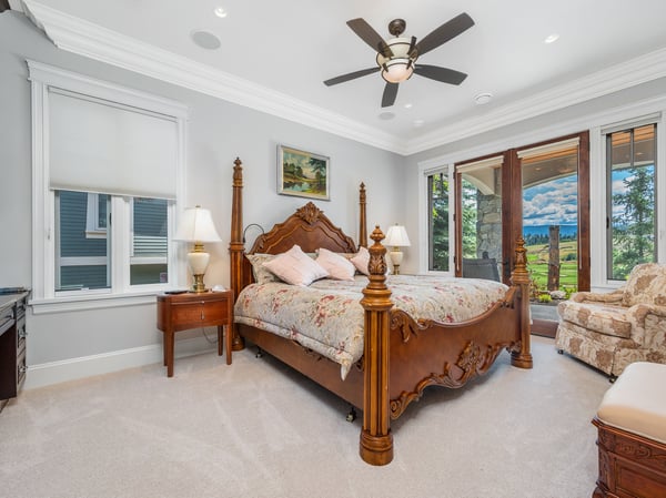 Spacious bedroom with ample natural light, and picturesque views from the private balcony.