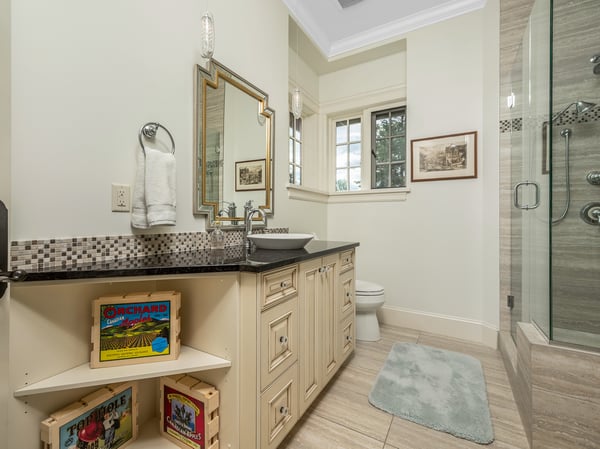 Modern bathroom featuring a spacious walk-in shower, sleek vanity, and convenient storage for essentials. Beautiful views from the windows.