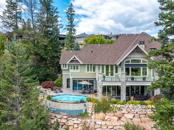Discover this spacious home featuring a private pool, expansive outdoor space, and stunning natural surroundings. This rear photo shows off the Craftsman architecture. Hope painted the summer of 2024.