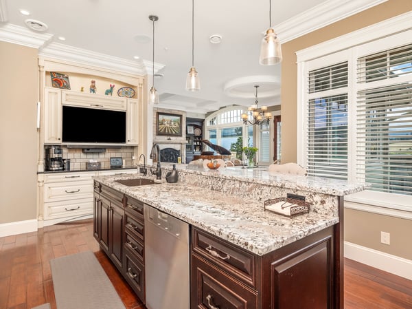Discover a well-designed kitchen featuring a large granite island, Miele, Wolf, and Sub-Zero appliances, and ample natural light and golf course views. The abundant cabinets have room for everything you will ever need for entertaining.