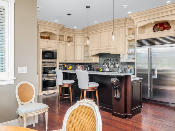 This inviting kitchen features custom cabinetry, a spacious island, and high-end appliances for culinary enthusiasts.