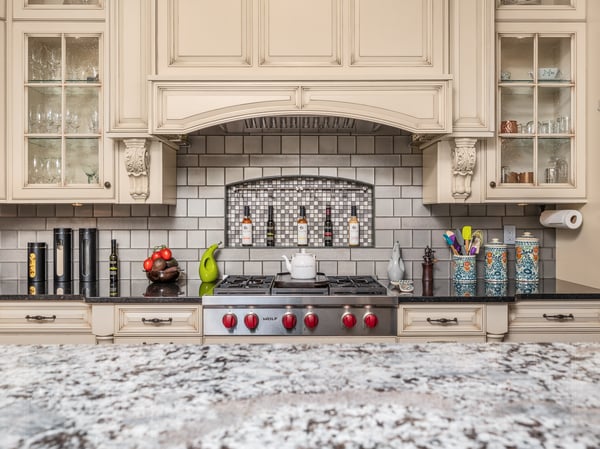 This well-appointed kitchen features modern appliances, custom cabinetry, and a striking mosaic backsplash for captivating culinary experiences.