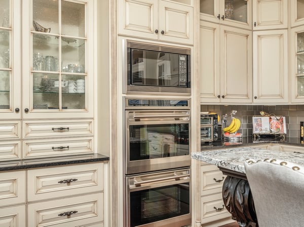 This gourmet kitchen features high-end appliances, custom cabinetry, and a spacious granite counter for entertaining.