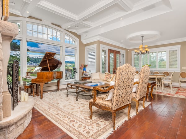 Spacious living room featuring a grand piano, stunning views, and abundant natural light throughout.