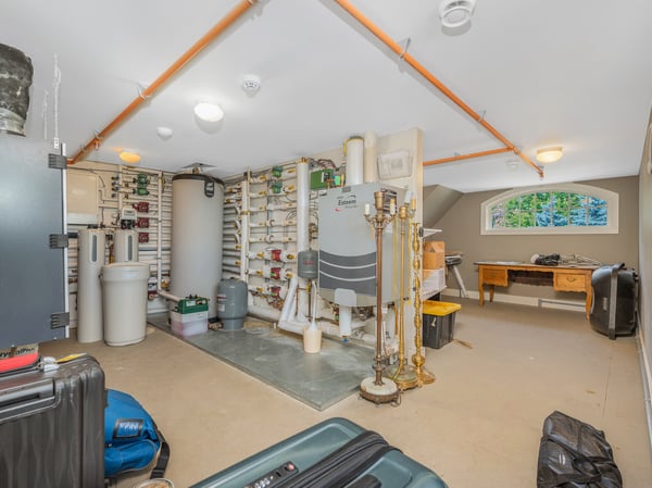 Spacious multi-purpose attic featuring ample storage, mechanical equipment, and a versatile art/work area for projects. easy access via stairway.