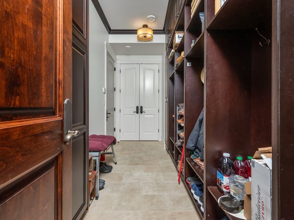 Spacious entryway features custom shelving and ample storage, offering a practical yet welcoming first impression.
