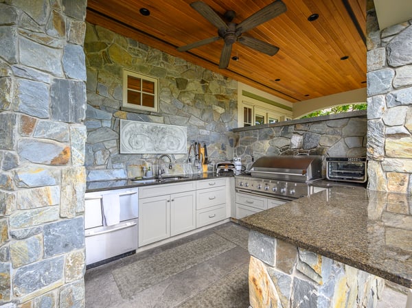 Discover this outdoor kitchen featuring natural stone finishes, premium appliances, and a spacious layout for entertaining.