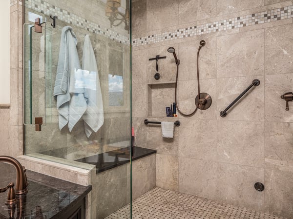 This beautifully designed bathroom features a spacious walk-in steam-shower with modern fixtures and practical accessibility.