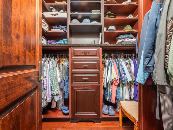 Spacious custom closet features organized shelving and ample hanging space for a stylish wardrobe.