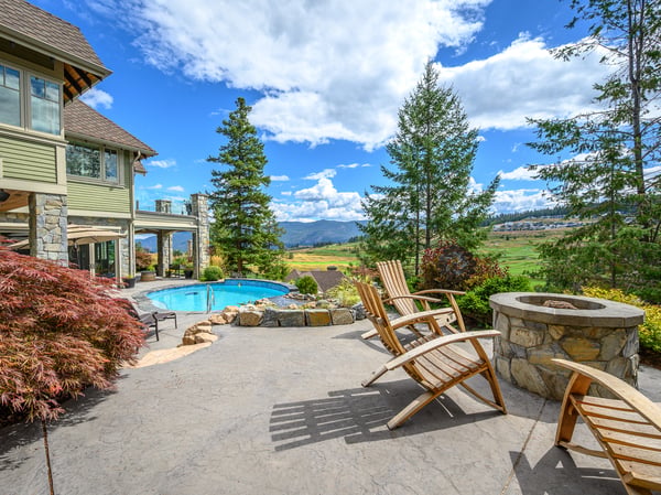 Discover a spacious outdoor retreat featuring a pool, fire pit, and stunning mountain views.