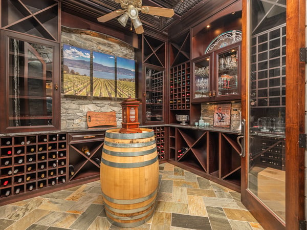 Discover a sophisticated wine cellar featuring custom racks and a stunning mural, perfect for entertaining.