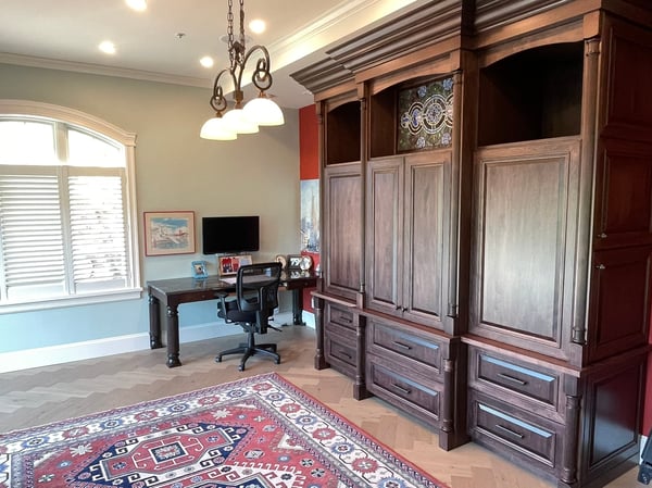 Spacious home office featuring built-in cabinetry, a dedicated workspace, and ample natural light for productivity.