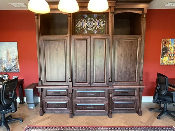 Spacious home office featuring custom cabinetry and dual desks, ideal for productivity and organization.