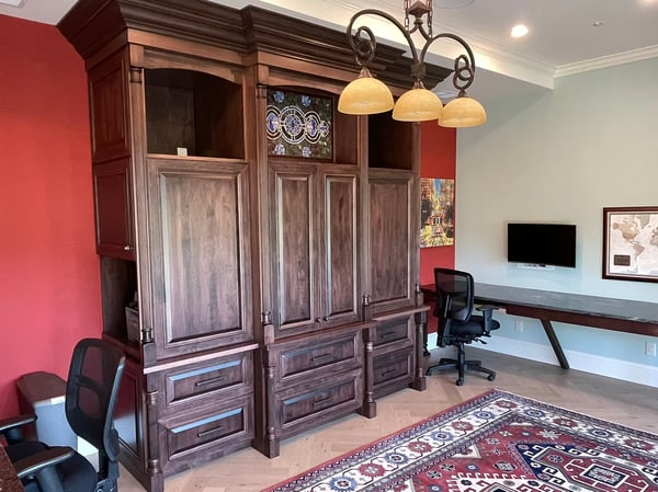 Spacious office area featuring custom cabinetry, modern workstations, and vibrant accent walls for inspiration.