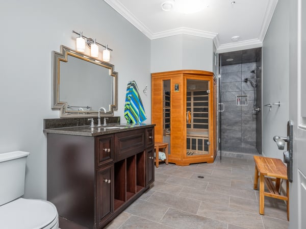 Discover a unique bathroom featuring modern fixtures, a sauna, and ample storage space for convenience.