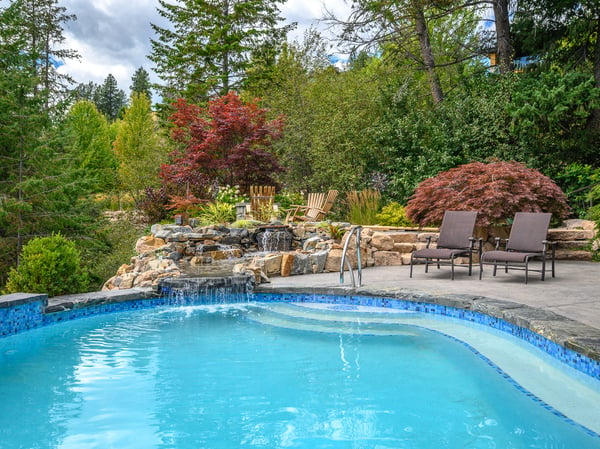 Relax by the inviting pool surrounded by lush greenery and tranquil water features. Perfect for unwinding.