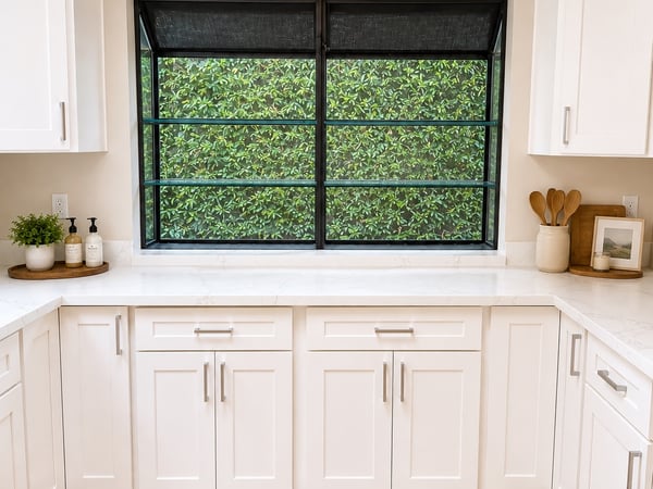 The kitchen features ample cabinetry, modern fixtures, and a large greenhouse window.
