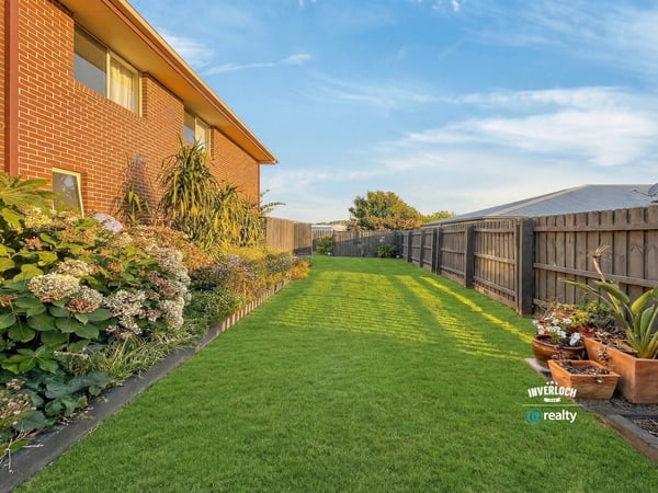 Spacious backyard oasis featuring lush greenery, perfect for outdoor gatherings and private relaxation.