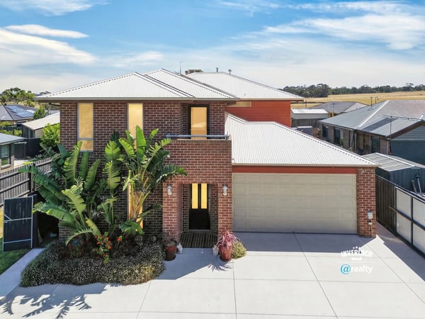 Modern home featuring a spacious layout, landscaped front yard, and ample natural light throughout.