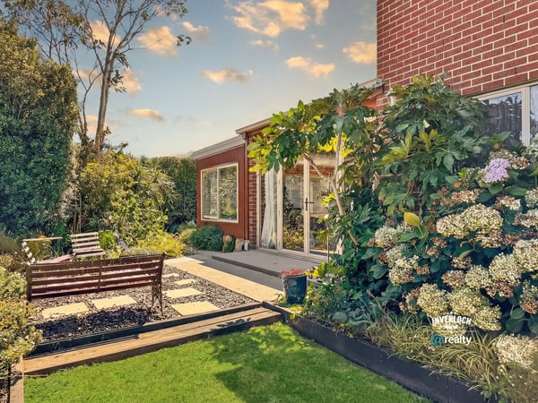 Discover this inviting outdoor space, featuring lush landscaping and a cozy seating area for relaxation.