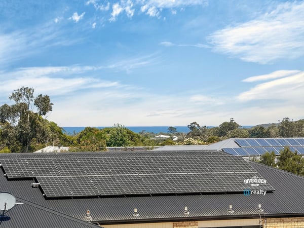 Modern home with solar panels and stunning ocean views, offering energy efficiency and coastal living.