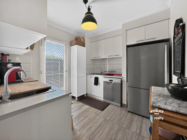 Modern kitchen featuring sleek appliances, ample storage, and natural light, perfect for culinary enthusiasts.
